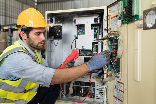 Electrician working on industrial panel